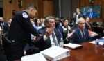 David Schertler, an attorney representing former NIH Director Anthony Fauci, is removed from the hearing room during a hearing before the Senate Homeland Security and Governmental Affairs Committee on July 29, 2026 in Washington.
