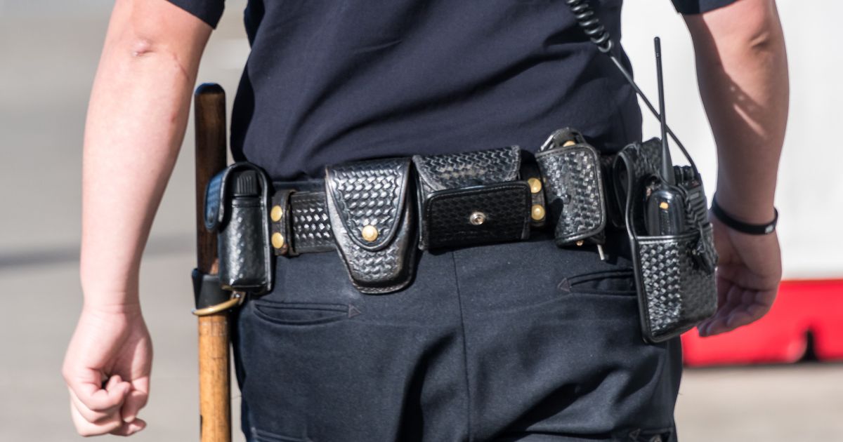A close-up shot of a police officer from behind.
