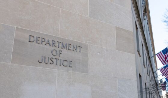 A Department of Justice sign on the side of the agency's headquarters in Washington.