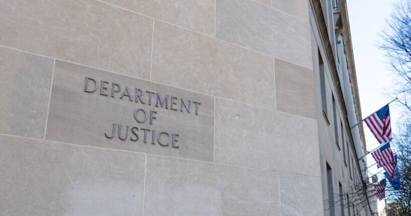 A Department of Justice sign on the side of the agency's headquarters in Washington.