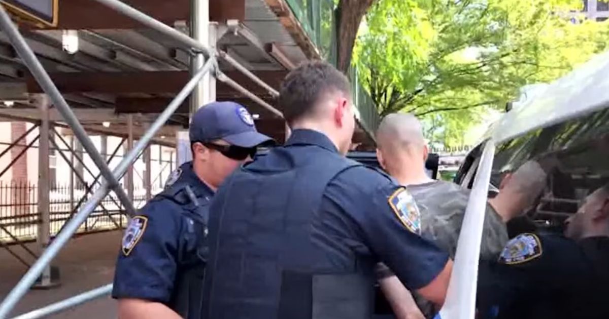 The suspect was taken into custody by New York City police officers after he barricaded himself in an apartment.