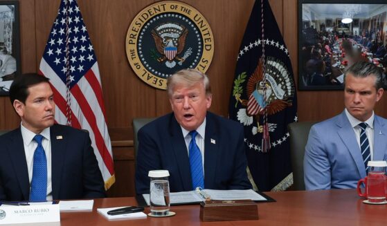 President Donald Trump speaks during a Cabinet meeting Friday at Camp David, the presidential retreat, flanked by Secretary of State Marco Rubio, left, and Secretary of Defense Pete Hegseth, right.
