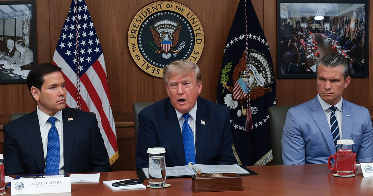 President Donald Trump speaks during a Cabinet meeting Friday at Camp David, the presidential retreat, flanked by Secretary of State Marco Rubio, left, and Secretary of Defense Pete Hegseth, right.