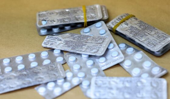 Metallic pill packets lay on a wooden table in New York on May 7, 2026.