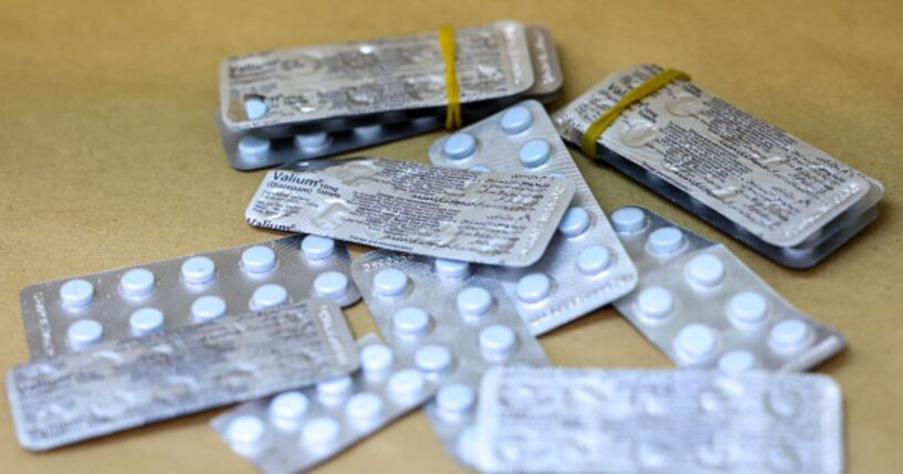 Metallic pill packets lay on a wooden table in New York on May 7, 2026.