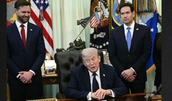 Vice President J.D. Vance, left, and Secretary of State Marco Rubio, right, listen to President Donald Trump speak during a meeting April 23 in Washington, D.C.