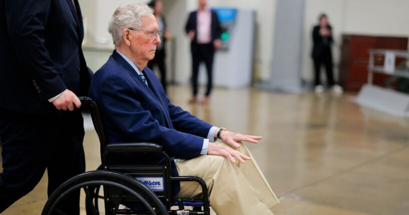 Sen. Mitch McConnel is pushed in a wheelchair through the Senate Subway during the Senate War Powers vote on April 22, 2026, in Washington, D.C.