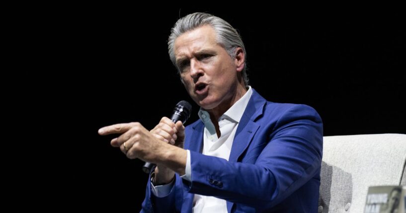 California Gov. Gavin Newsom gestures at an event promoting his book 