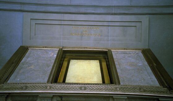 The Declaration of Independence, displayed in a dimly lit hall at the National Archives, reserved for the original Charters of Freedom in Washington, D.C.