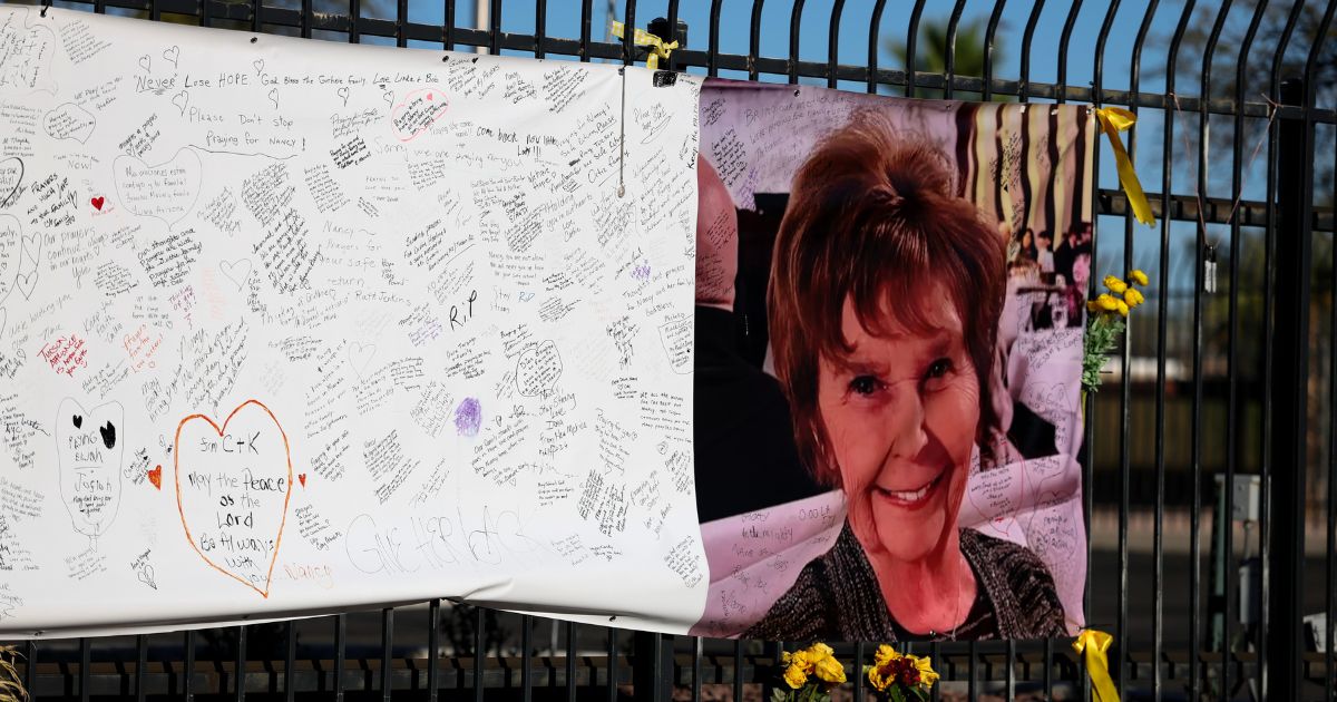 A photograph of Nancy Guthrie is seen on a sign that people can leave messages on Feb. 26, 2026, in Tucson, Arizona.