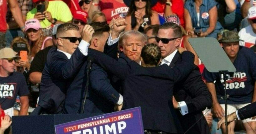 President Donald Trump is seen with blood on his face surrounded by Secret Service agents as he is taken off the stage at a campaign event at Butler Farm Show Inc. in Butler, Pennsylvania, on July 13, 2024.