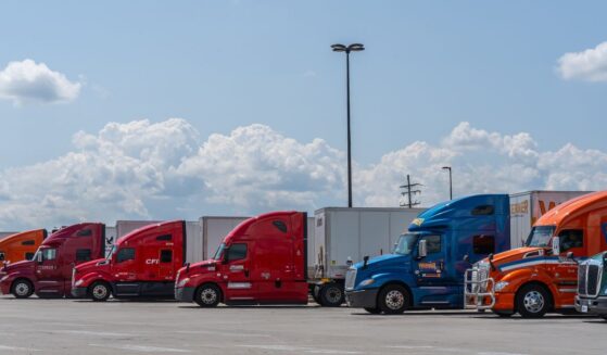 Semi-trucks parked in a lot at rest stop on the Pennsylvania Turnpike in Somerset, Pennsylvania, on July 23, 2023.