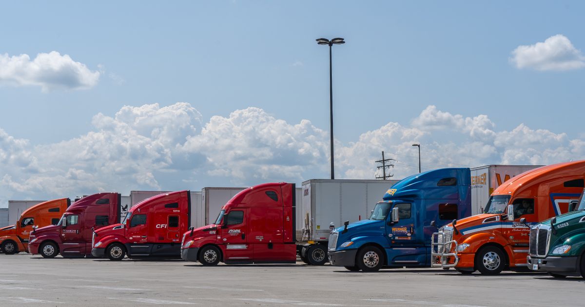 Semi-trucks parked in a lot at rest stop on the Pennsylvania Turnpike in Somerset, Pennsylvania, on July 23, 2023.