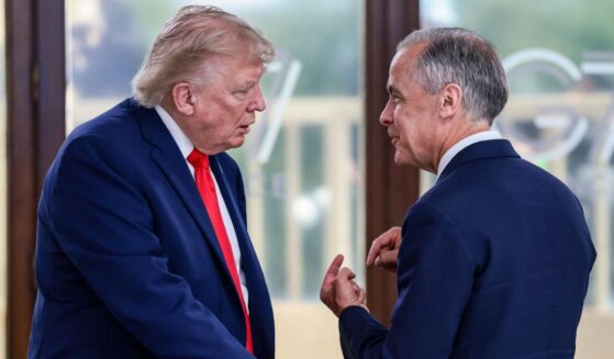 President Donald Trump speaks with Canada's Prime Minister Mark Carney during a working lunch as part of the G7 summit, in Evian, eastern France, on June 16, 2026.