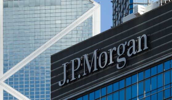 The JPMorgan sign is displayed on an office building with the Bank of China Tower in the background on June 21, 2026, in Hong Kong, China.