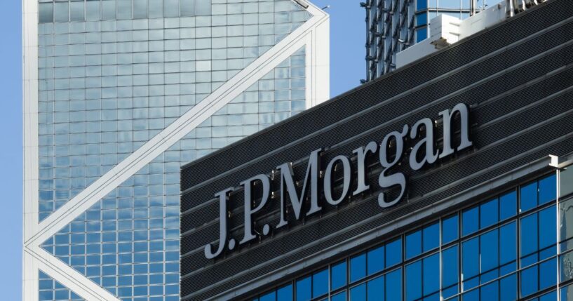 The JPMorgan sign is displayed on an office building with the Bank of China Tower in the background on June 21, 2026, in Hong Kong, China.