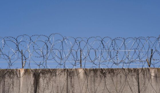 A prison wall with barbed wire in Frankfurt, Germany.