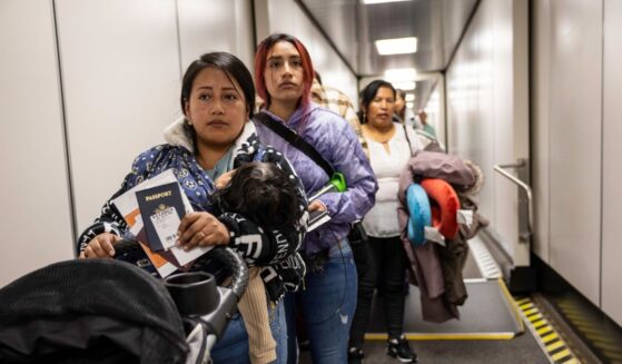 Andrea, and her cousin Jennyfer, nervously prepare to board their flight to Ecuador from JFK International Airport on Oct. 27, 2025, in New York, New York.