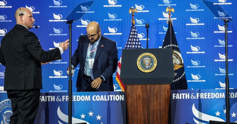 White House teleprompter operators, including Gabriel Perez, set up a teleprompter before President Donald Trump speaks at the Faith & Freedom Coalition's 2026 Policy Conference at the Washington Hilton on June 26, 2026, in Washington, D.C.