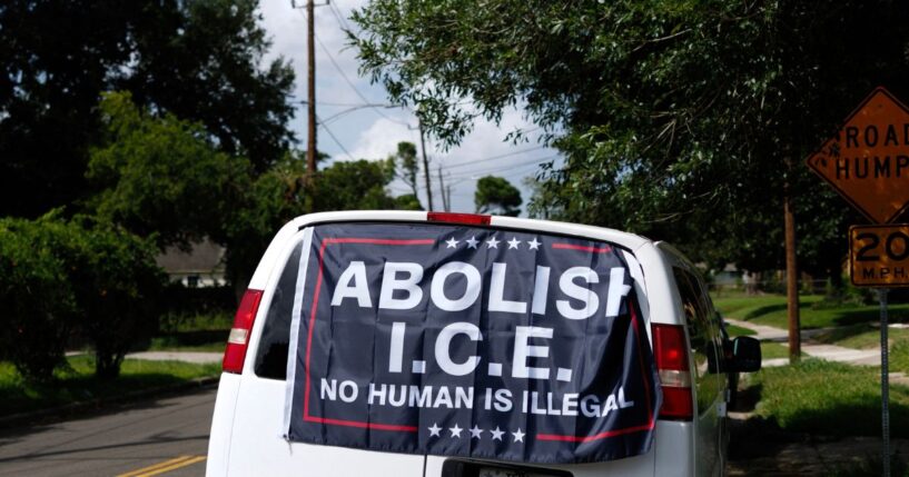 A banner reading "Abolish ICE, No Human is Illegal" is displayed on a van in Houston, Texas.