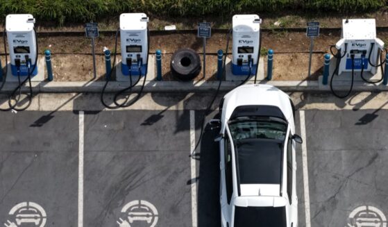 In an aerial view, an electric vehicle charges at an EVgo electric charger on March 30, 2026, in Monrovia, California.