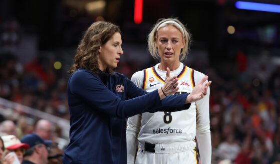 Sophie Cunningham of the Indiana Fever talks with head coach Stephanie White during the game against the Phoenix Mercury at Gainbridge Fieldhouse on June 24, 2026, in Indianapolis, Indiana.
