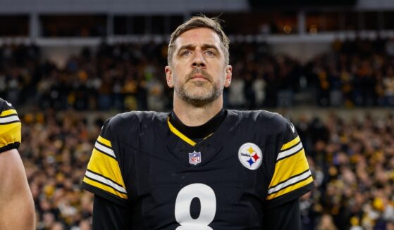 Aaron Rodgers of the Pittsburgh Steelers stands for the national anthem prior to the AFC Wild Card playoff game against the Houston Texans at Acrisure Stadium on Jan. 12, 2026, in Pittsburgh, Pennsylvania.