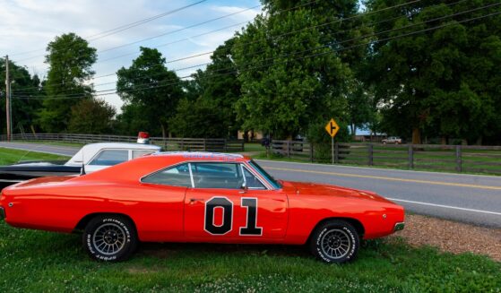 Replicas of the General Lee Charger and the Sheriff car, from the television series The Dukes of Hazzard, parked along a country road in the state of Tennessee on June 26, 2014.