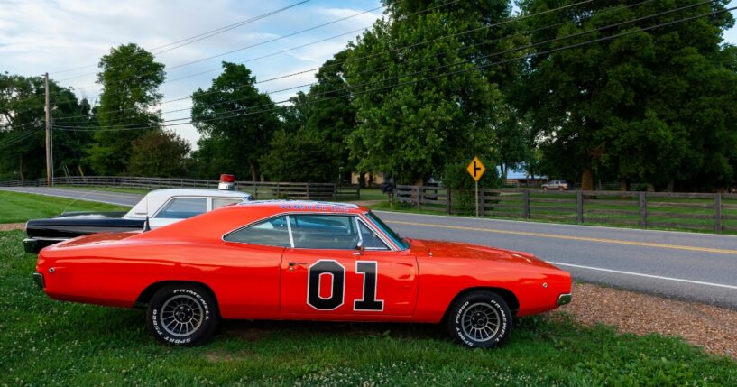 Replicas of the General Lee Charger and the Sheriff car, from the television series The Dukes of Hazzard, parked along a country road in the state of Tennessee on June 26, 2014.
