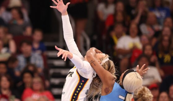 Sophie Cunningham of the Indiana Fever is fouled by DiJonai Carrington of the Chicago Sky during the first half at United Center on Aug. 8, 2026, in Chicago, Illinois.