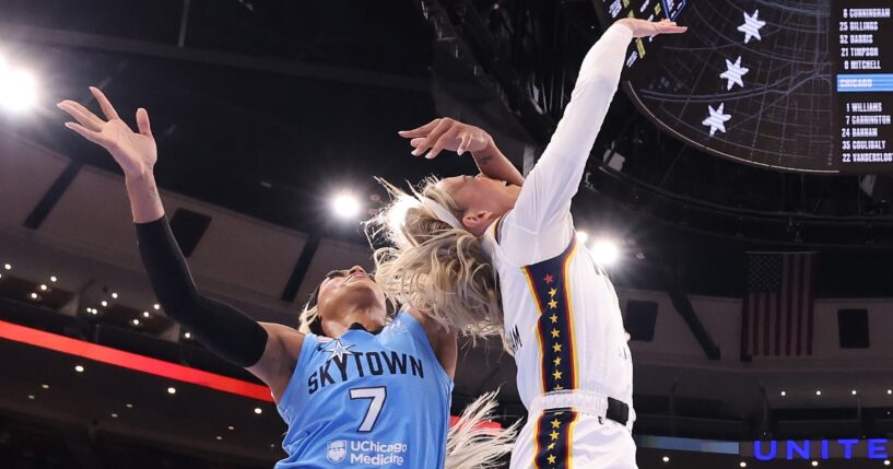 Sophie Cunningham of the Indiana Fever is fouled by DiJonai Carrington of the Chicago Sky during the first half at United Center on Aug. 8, 2026, in Chicago, Illinois.