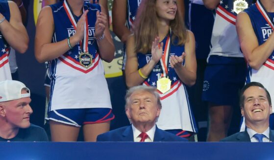President Donald Trump sits next to sports analyst Pat McAfee as he attends the 2026 Patriot Games at SPIRE Academy on Aug. 11, 2026, in Geneva, Ohio.