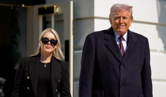 President Donald Trump, accompanied by White House Press Secretary Karoline Leavitt, walks toward the media as he departs on Marine One on the South Lawn of the White House on Feb. 27, 2026, in Washington, D.C.