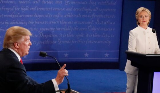 Democratic nominee Hillary Clinton looks on as Republican nominee Donald Trump speaks during the final presidential debate at the Thomas & Mack Center on the campus of the University of Las Vegas in Las Vegas, Nevada, on Oct. 19, 2016.