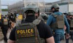Immigration and Customs Enforcement agents block protesters as cars exit Delaney Hall, which is being used as an Immigration and Customs Enforcement detention center, on May 27, 2026, in Newark, New Jersey.