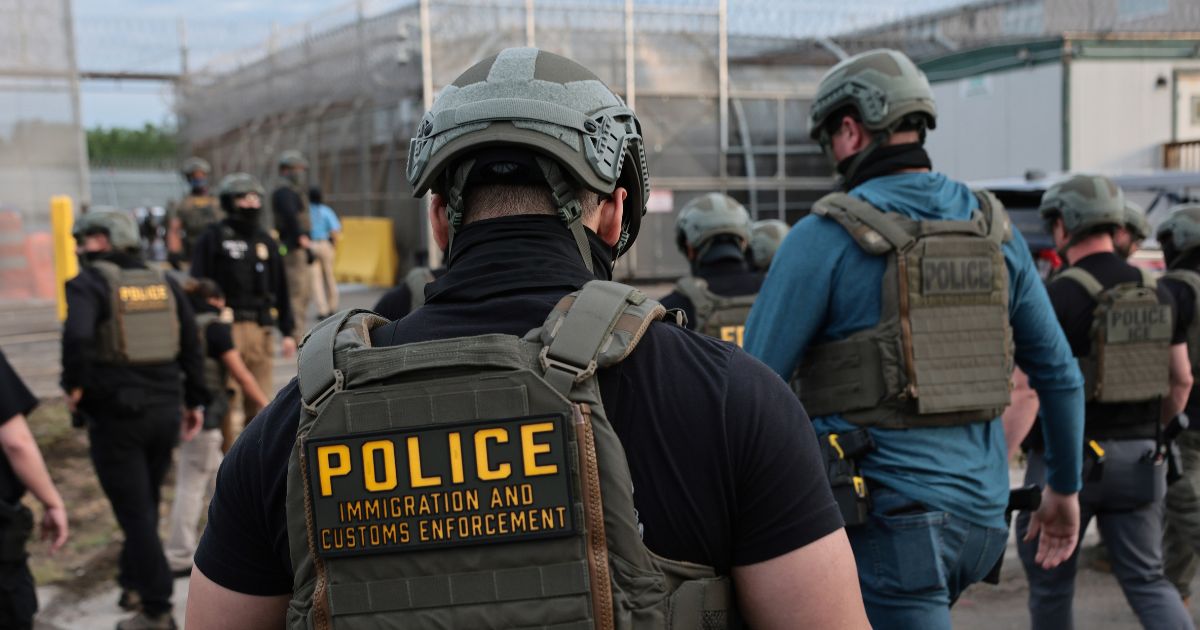 Immigration and Customs Enforcement agents block protesters as cars exit Delaney Hall, which is being used as an Immigration and Customs Enforcement detention center, on May 27, 2026, in Newark, New Jersey.