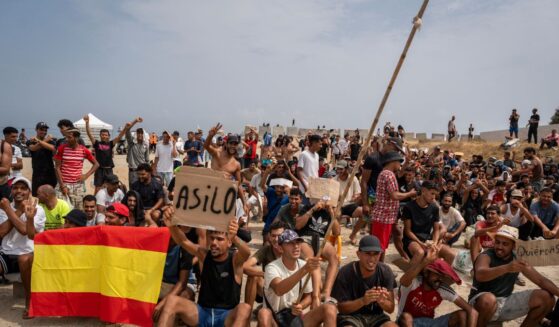 Migrants, mainly Moroccan, gather in a protest asking for asylum in El Trampolin beach on Aug. 16, 2026, in Ceuta, Spain.