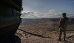 A U.S. Army soldier stands next to a Stryker armored infantry transport vehicle, which has been deployed along the U.S.-Mexico border as part of the military's Joint Task Force Southern Border mission, in Sunland Park, New Mexico, on April 4, 2025.