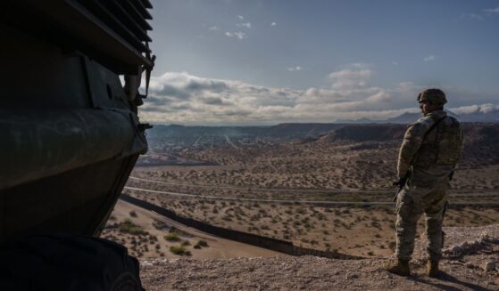 A U.S. Army soldier stands next to a Stryker armored infantry transport vehicle, which has been deployed along the U.S.-Mexico border as part of the military's Joint Task Force Southern Border mission, in Sunland Park, New Mexico, on April 4, 2025.