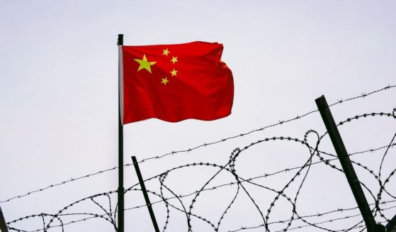 Prison bars with a Chinese flag.