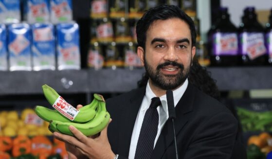 New York City Mayor Zohran Mamdani holds up bananas as he speaks at a food distribution center on July 27, 2026, in the Brooklyn borough of New York City.