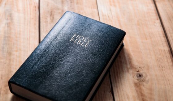 A Bible on a wooden table background.