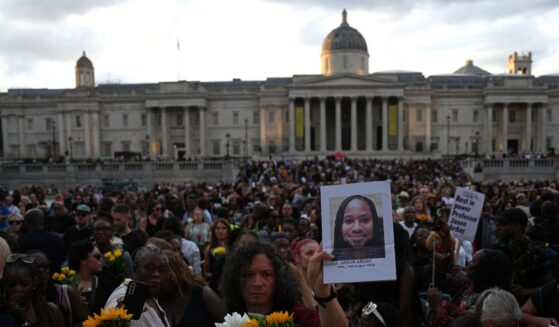Supporters leave flowers and photographs after taking part in a vigil for late Cambridge professor Jason Arday in Trafalgar Square in central London on Aug. 17, 2026, following his death at age 41.