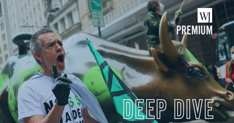 Climate activists hold a protest at the Charging Bull statue in Bowling Green near the New York Stock Exchange on April 22, 2025, in New York City.