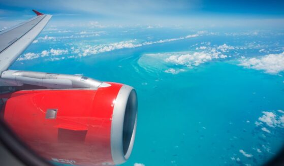 A passenger jet flies over the Caribbean Ocean near Haiti. The U.S. deported 162 individuals back to Haiti Aug. 20, many of whom have lengthy rap sheets.