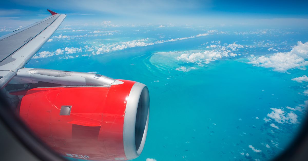 A passenger jet flies over the Caribbean Ocean near Haiti. The U.S. deported 162 individuals back to Haiti Aug. 20, many of whom have lengthy rap sheets.