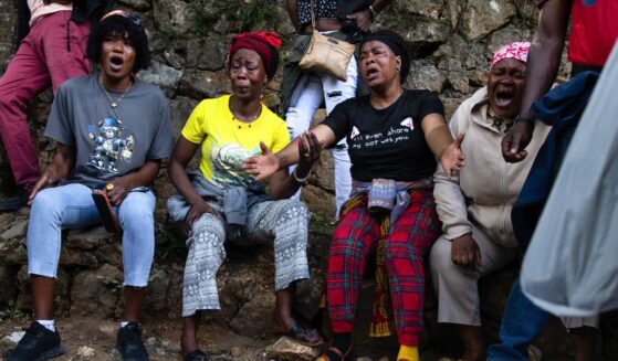 Haitians react in grief following overnight violence where more than 40 people were killed by armed gangs in Kenscoff, a neighborhood near Port-au-Prince, Haiti.