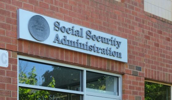 A brick Social Security Administration building stands in the sunshine.