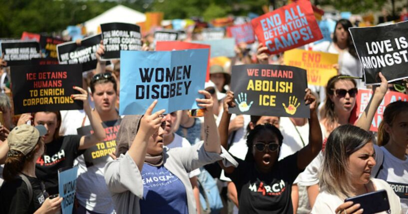 A gathering outside the Trump hotel building emerges to protest Republican policy on June 28, 2018.