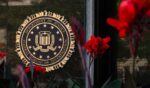 The FBI signage is displayed among a bed of flowers in Washington, D.C. on August 8, 2026.